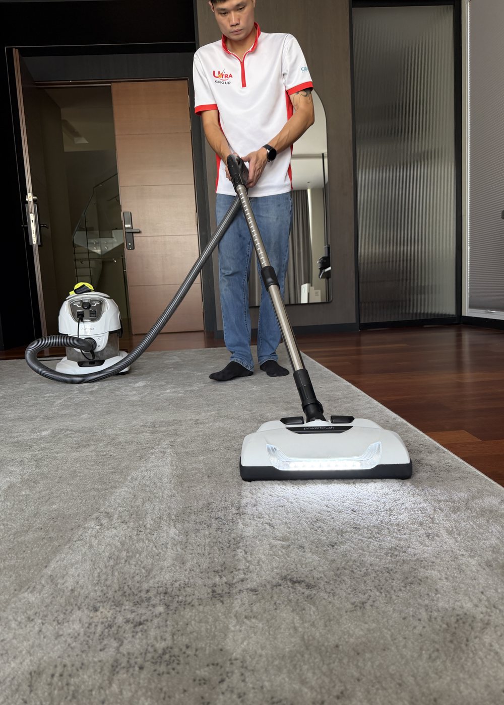 Home Care technician deep cleaning a living room carpet with a powered extraction machine